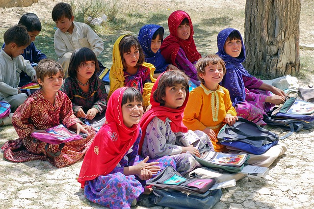 Afghan children studying in a open air school